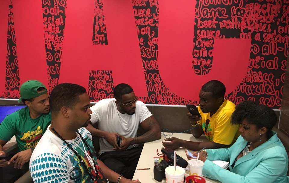 Aarius Dumas’s friends planning an early shoot around a table, with a RØDE microphone and notes